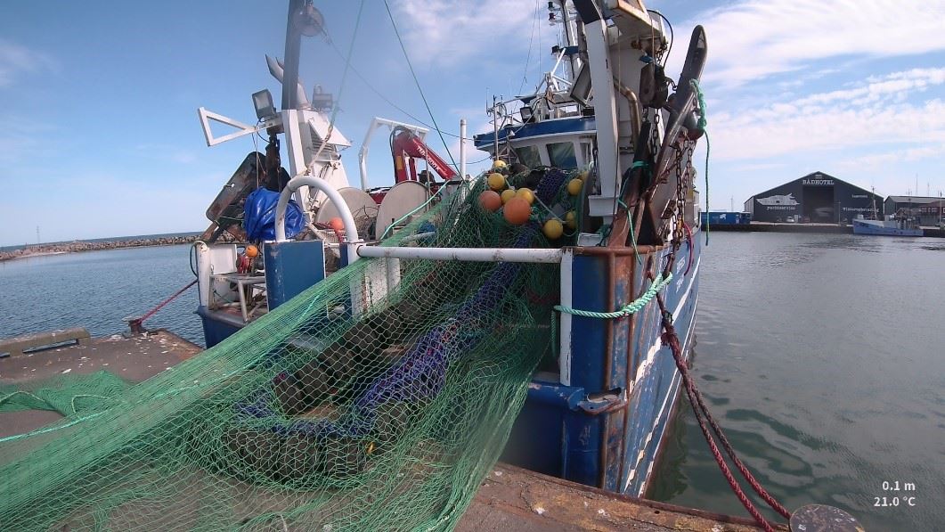 Boat with trawl.