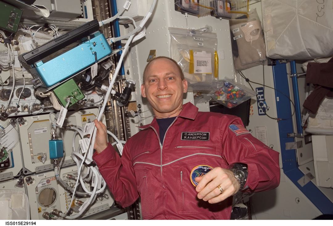 NASA astronaut Clayton Anderson with ANITA on the ISS at the time of system start-up in September 2007. ANITA is contained in the two EXPRESS rack inserts behind Clay’s right hand and lower arm. The control laptop computer is mounted on the blue box in the upper left-hand corner. Photo: NASA.