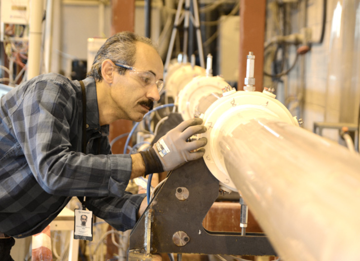 Person handles a pipe