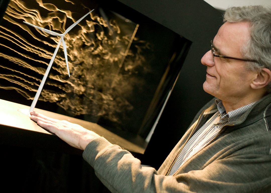 Ove Grande in front of wind turbine in a wind tunnel