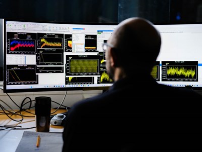 Man in front of screens