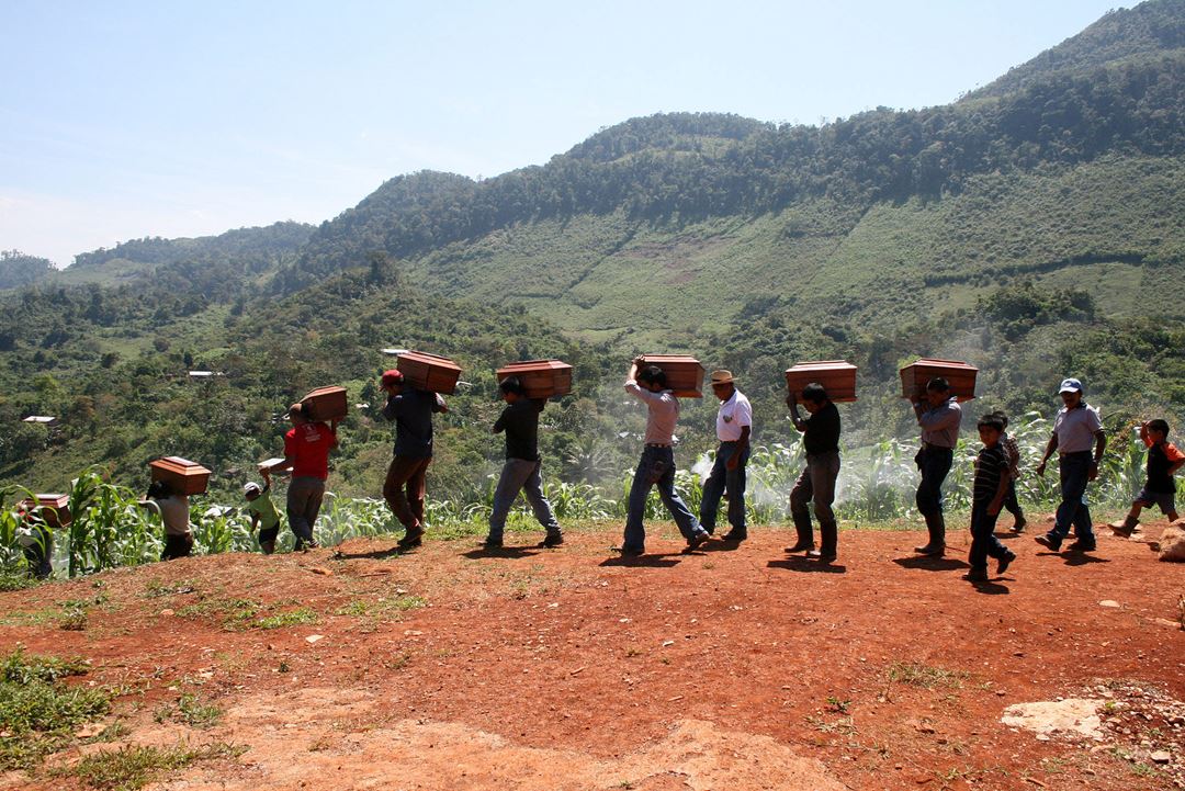 Queqchí people carrying their loved one's remains after an exhumation in Cambayal in Alta Verapaz department, Guatemala