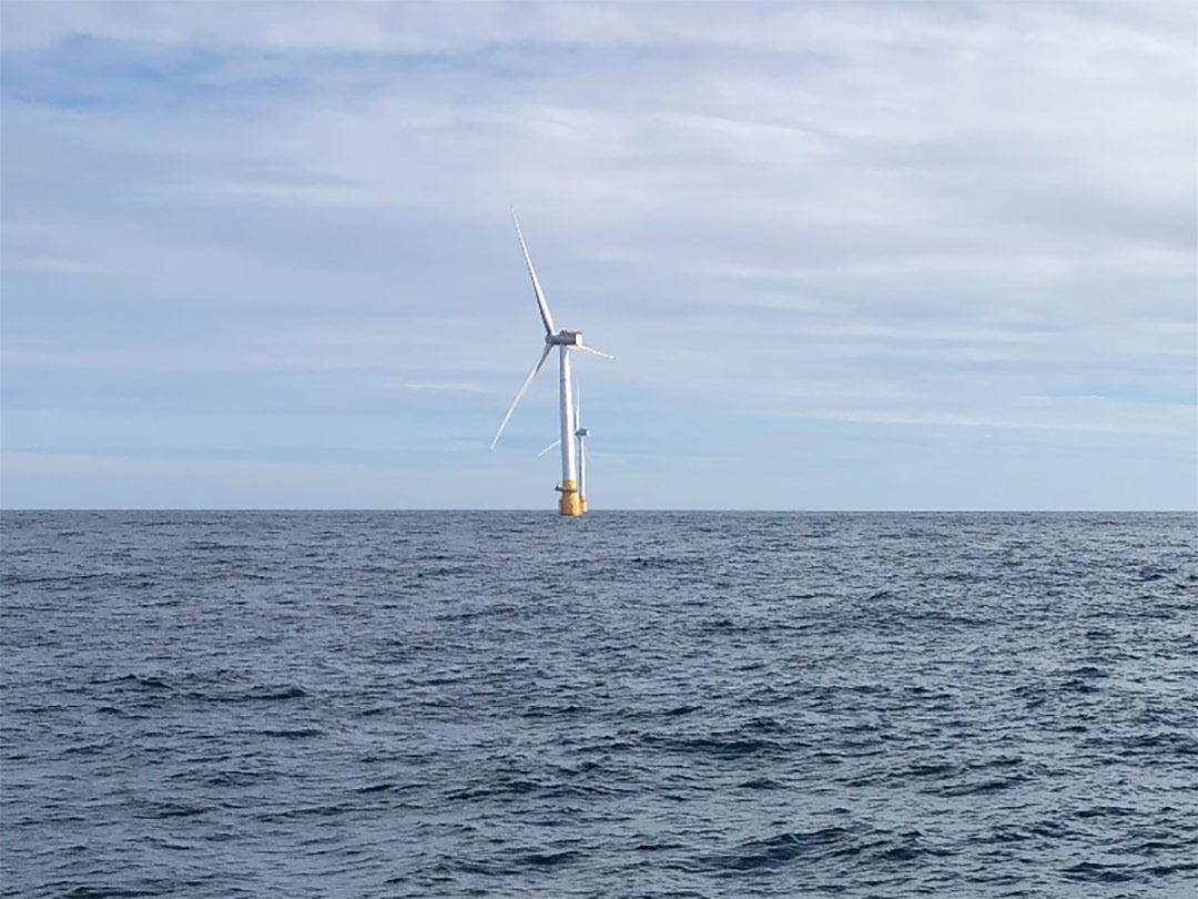 Floating offshore wind turbine surrounded by sea.