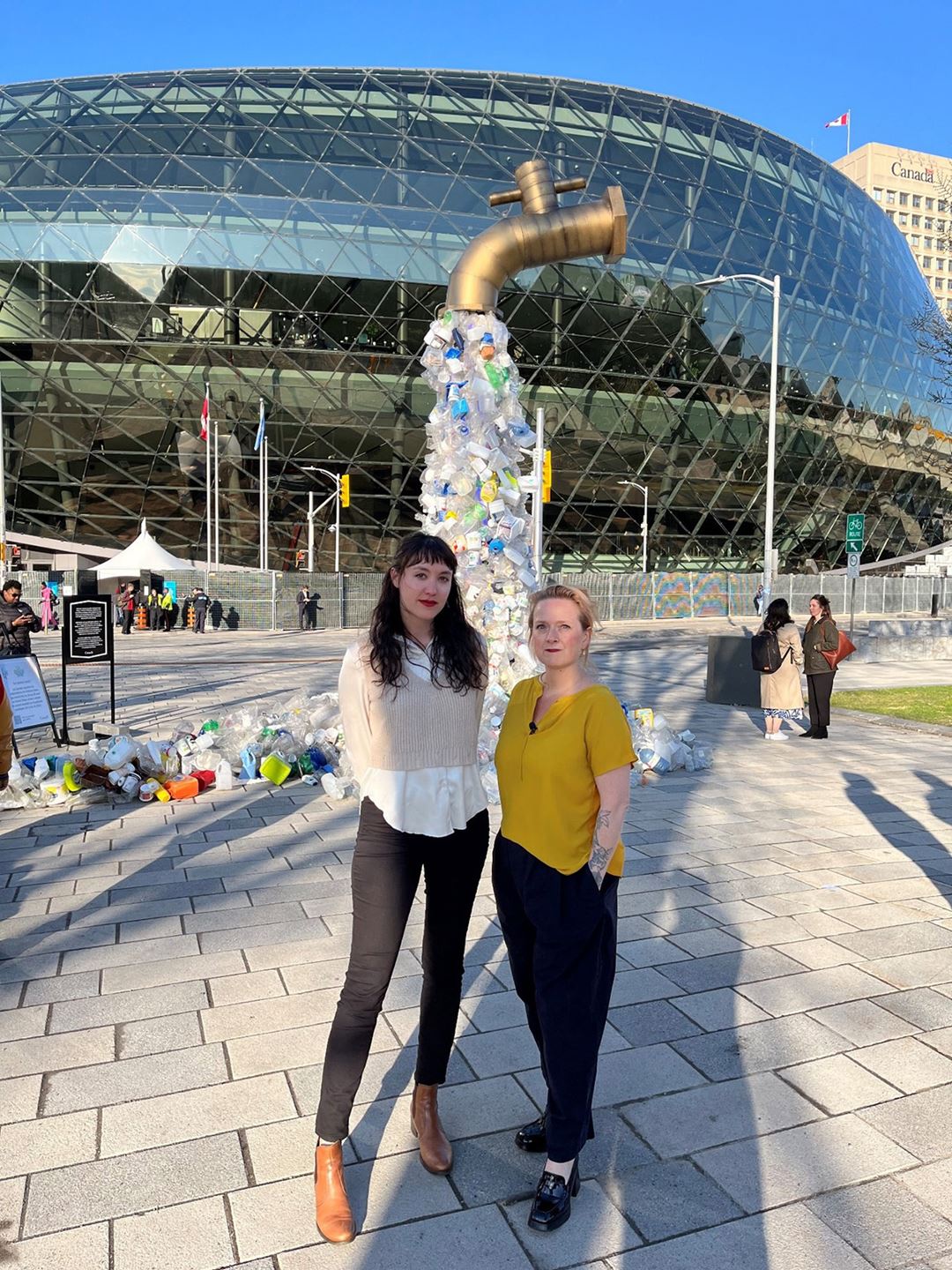 Emily Cowan and Rachel Tiller in front of the giant tap.
