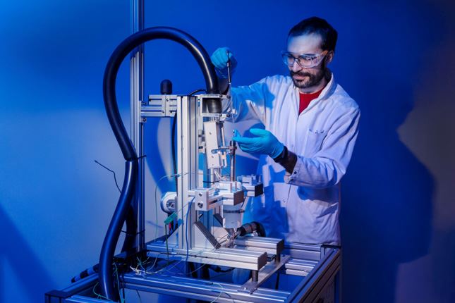Blue picture of a person working on a machine