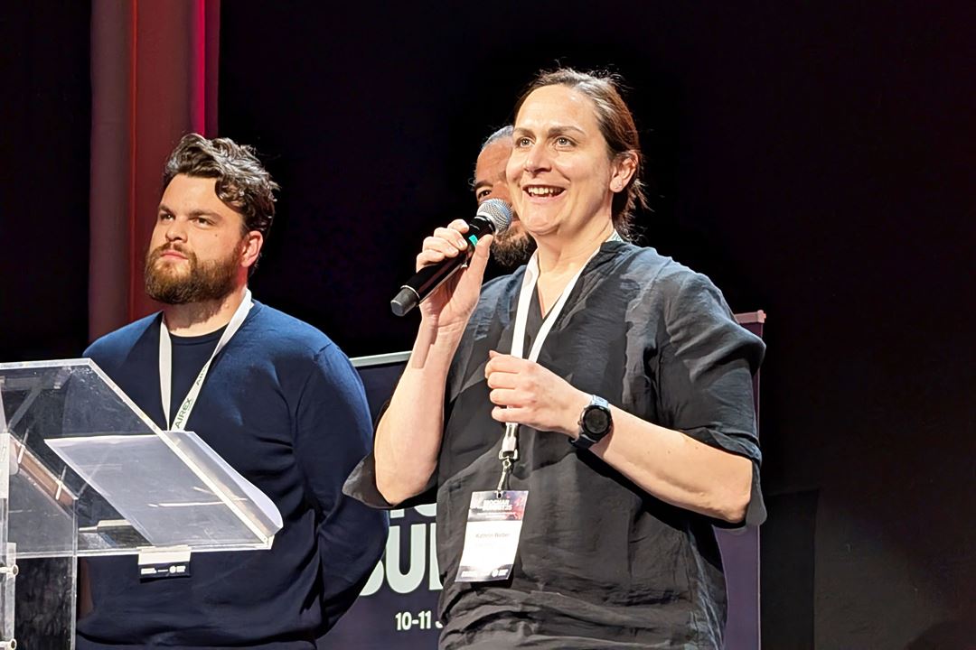 Kathrin Weber (SINTEF) closes the 2025 Biochar Summit on stage with Troy Robichaud (Biochar Europe) and Harald Bier (Biochar Europe).