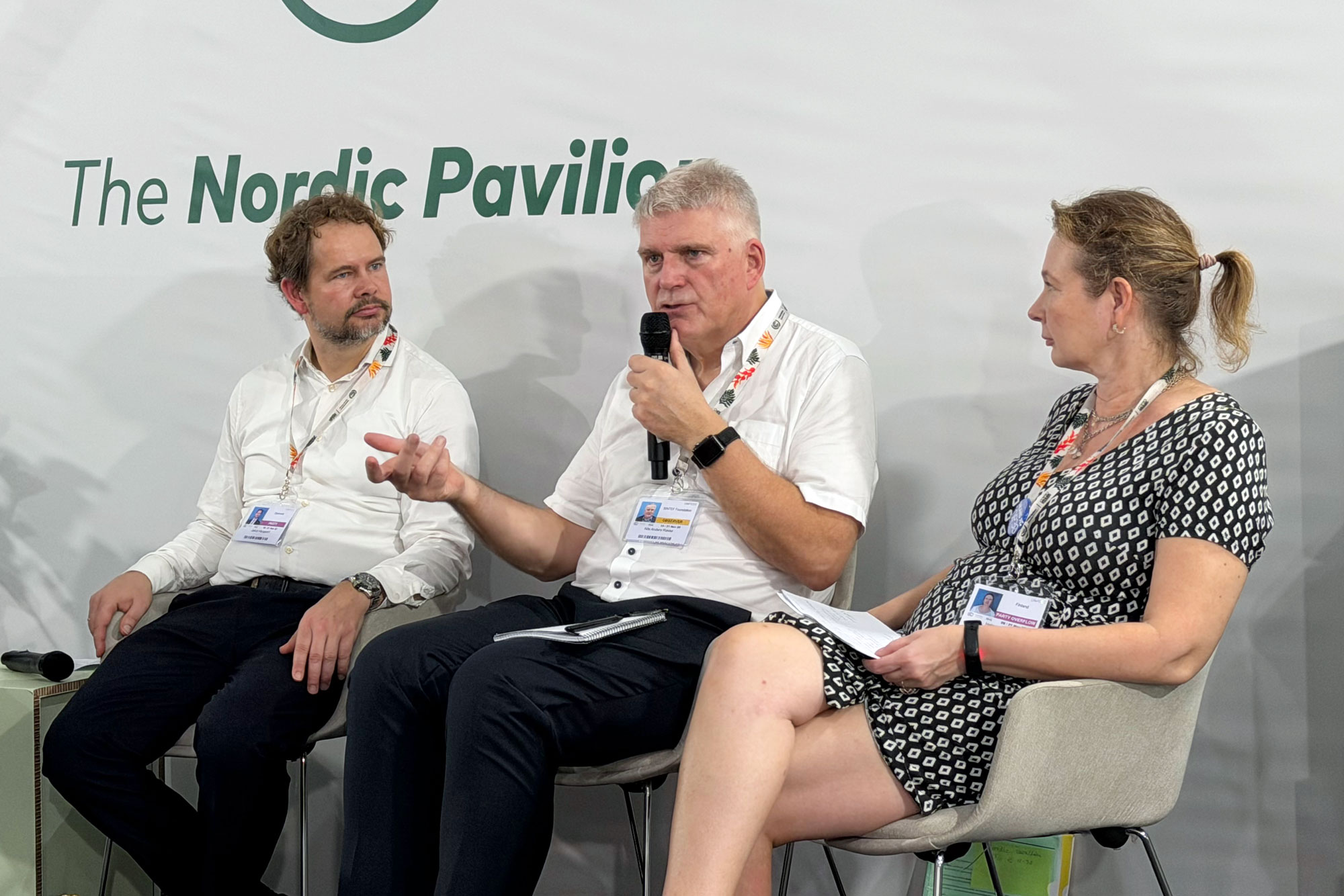 Three people sitting and talking