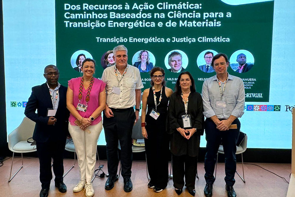 People standing in a line in front of a screen