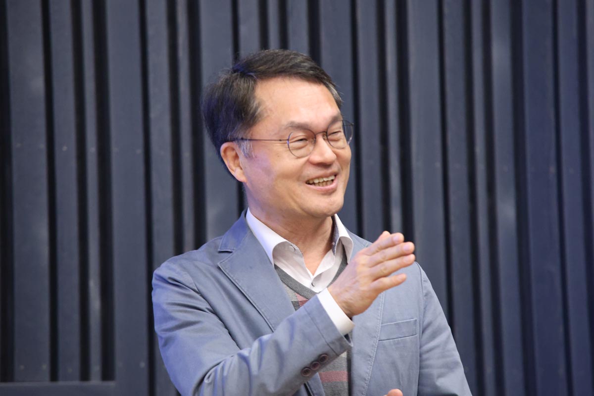 A person holding a presentation in a conference setting.