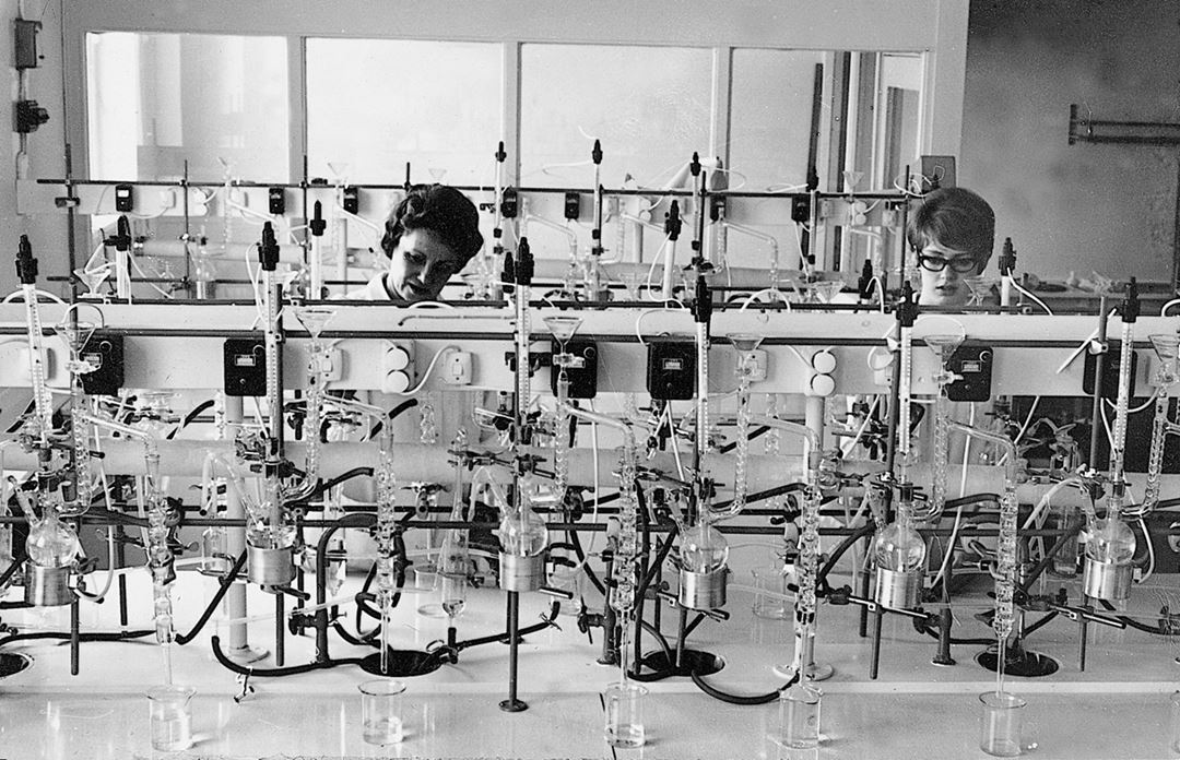 To kvinner står og jobber på et laboratorium.