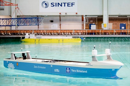 Blue ship model in the ocean basin