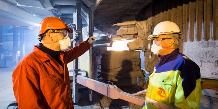 The Norwegian silicon industry is reducing dust concentrations in the air around its furnace operators. In order to remove dust during tapping, Bernd Wittgens of SINTEF (left) and Halvard Tveit of Elkem and NTNU have led the development of a new extraction system that Elkem’s works at Thamshavn have been the first to adopt. Photo: SINTEF/Thor Nielsen