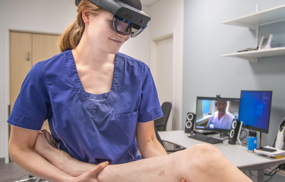 Fysioterapeut Anna Osen Byberg (med hololensbriller) samarbeider her med ortoped Ivar Hanssen på Helgelandssykehuset. Ortopeden kan se pasienten og samtidig gi instruksjoner til fysioterapeuten i sann tid. Foto: Helgelandssykehuset