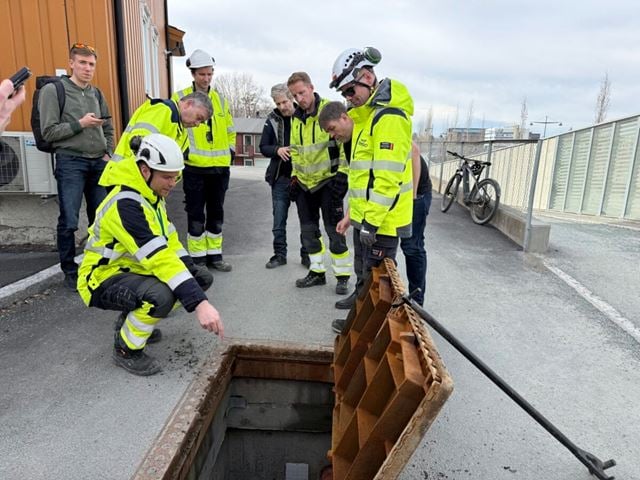 Her inspiseres en kum for kabler. Kummene er luftet, og det oppstår en skorsteinseffekt i de tomme rørene. Dette gir naturlig ventilasjon og kjøling ved at luft sirkulerer gjennom kabelrørene. Sammen med dem går det nå vannrør som skal brukes for å kjøle kablene. En del av INCA-prosjektet er å finne ut hvor stor effekt et slikt vannkjølende system har. Foto: Hege Tunstad