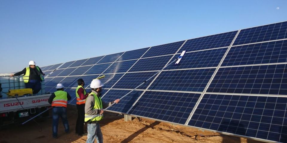 Manual cleaning being carried out at Scatec Solar’s solar energy farm in Jordan. Photo: Mohammad Ba’ra.