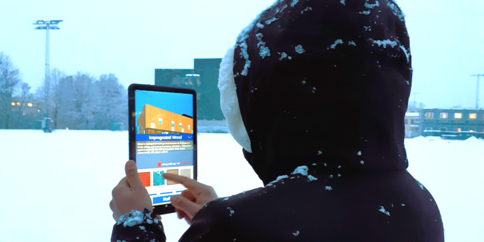 The participants in the study used an AR app at Voldsløkka secondary school and cultural centre in Oslo to envisage a building constructed using various alternative façade materials with different carbon footprints. Photo: SINTEF
